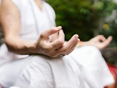 Detail of a person hands in a mudra position